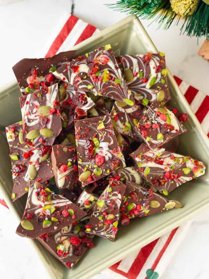 chocolate bark cut into pieces placed in a green bowl.