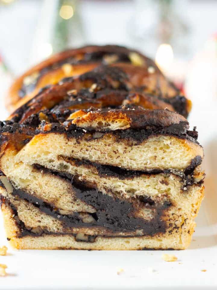 sliced chocolate babka on a platter to show the swirls in the bread.