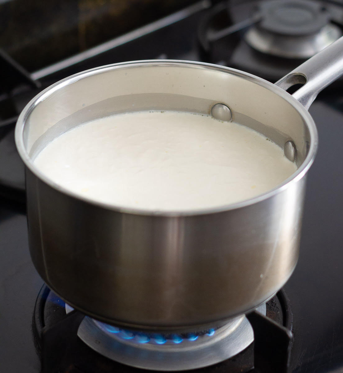 Gently boil milk, cream and salt