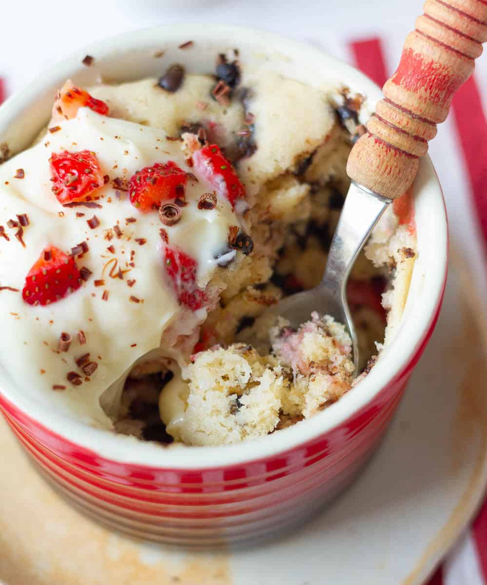 taking a bite of the mug cake with a spoon