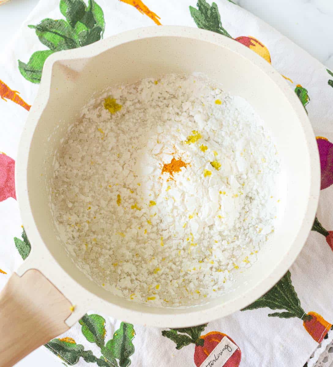 sugar, cornstarch, turmeric and lemon zest in a saucepan